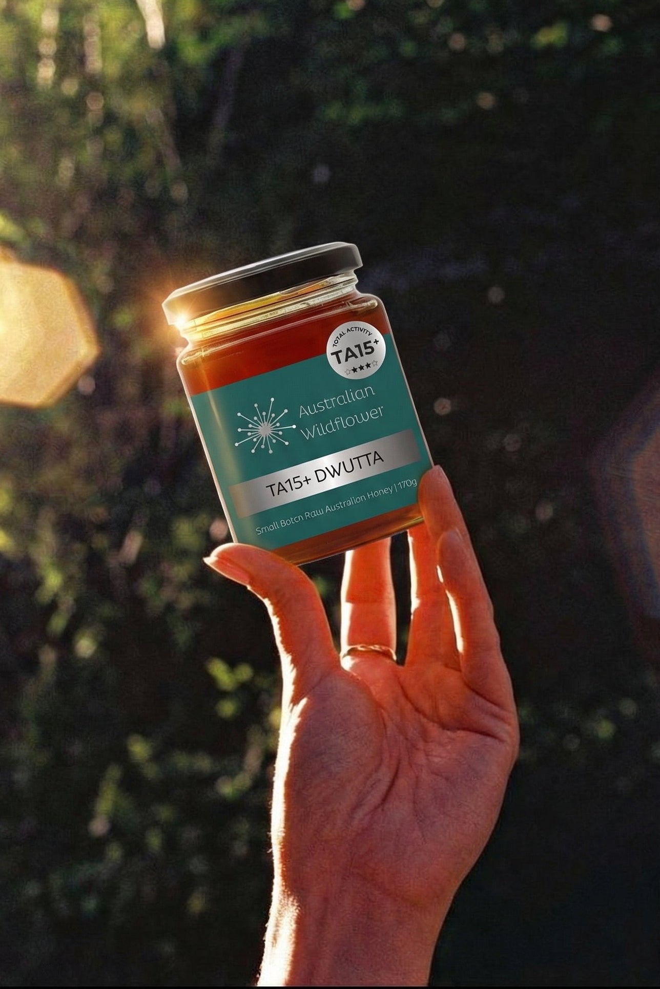 Hand holding a jar with a natural background